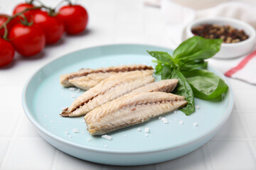 Canned mackerel fillets served on white tiled table, closeup
