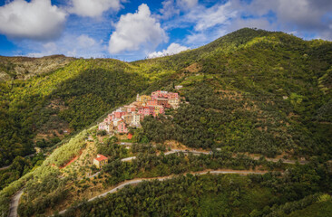 Naklejka na ściany i meble A small village lavaggiorosso high up in the mountains near Levanto on the Ligurian coast. Secluded and almost forgotten it looks at us. Aerial drone picture. September 2021