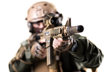 soldier fully equipped with tactical gear aiming at enemy with sniper rifle. shallow focus on rifle. isolated on white background.