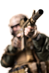 soldier fully equipped with tactical gear aiming at enemy with sniper rifle. shallow focus on...