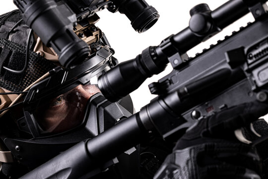 soldier fully equipped with tactical gear aiming at enemy with sniper rifle. abstract rifle and face with protective mask and night vision goggles.