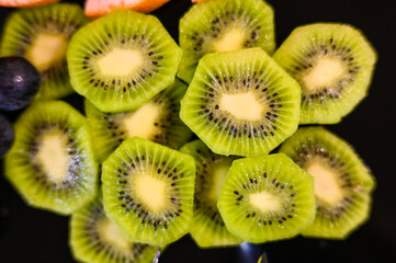 Slice of fresh kiwi on a plate.