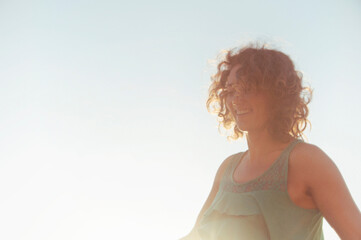 Joyful woman playing yoga and with the wind in her hair. 