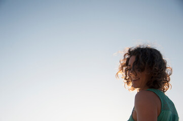 Joyful woman playing yoga and with the wind in her hair. 