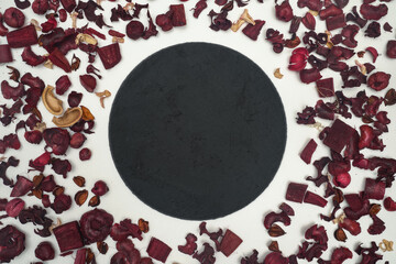 Round stone dish with red leaves all over the surface