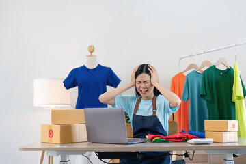 Stress serious asian woman doing clothing business selling online. she using laptop computer. online sell marketing delivery, SME e-commerce telemarketing concept