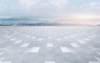 Empty brick floor square with panoramic views of the city skyline and architecture