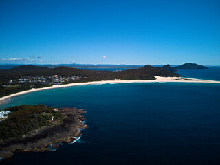 Fototapeta premium Drone photo of Fingal Bay and the spit leading to Shark Island on a bright sunny day