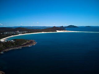 Fototapeta premium Drone photo of Fingal Bay and the spit leading to Shark Island on a bright sunny day