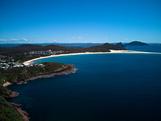 Drone photo of Fingal Bay and the spit leading to Shark Island on a bright sunny day