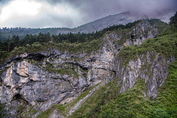 Dramatic sky over the Jade Dragon Snow mountain in Lijiang, China. Footsteps bottom of the mountain