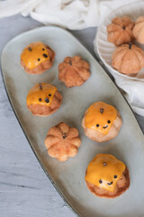 Creative homemade pastry. Pumpkin Shape Halloween Tea Cakes. Common baking ingredients and baking molds
