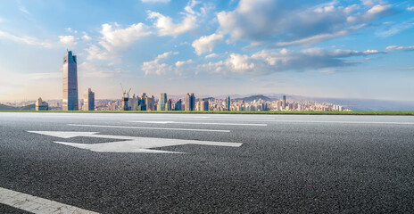 Background of asphalt pavement and urban architectural landscape skyline
