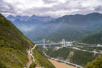 Looking at the Jinsha River in the Tiger Leaping Gorge from the hiking high way on the mountainside, the river looks green under the sun.