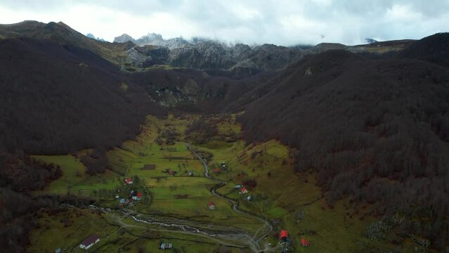 Paradise Alpine village on valley surrounded by trees forest and rocky mountains in Autumn, Lepushe Albania