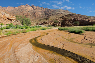 Meandering ephemeral river in the rugged landscape of the Brandberg mountain, Namibia.