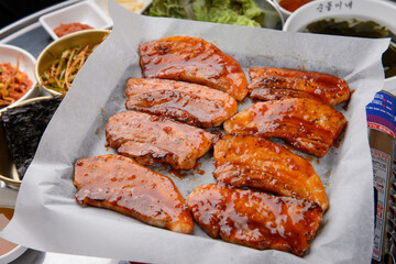 The pork belly is being grilled