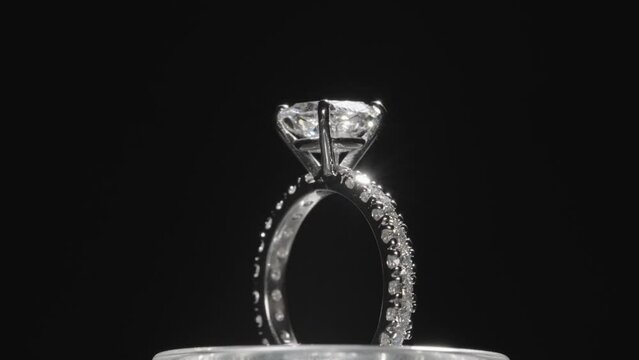 Beautiful diamond ring rotating against a black studio background