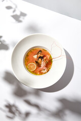 Traditional italian fish soup with shrimp, mussels and salmon. Seafood soup on white background....