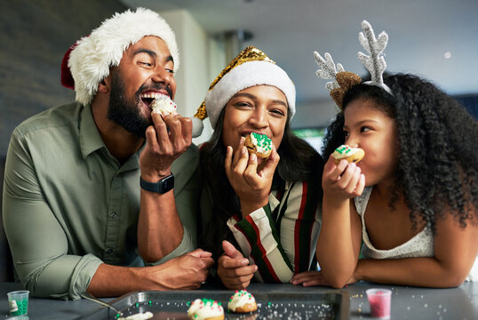 Family, christmas and eating cookies together after baking and cooking for bonding and learning. Bake, cook and sweet biscuit dessert with a mother, father and daughter enjoying food snack
