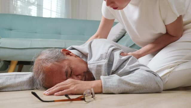 Older senior man headache lying on the floor after falling down he pain and hurt from osteoporosis, Elderly man falling on the floor alone with walking stick at home, Health care and medicine