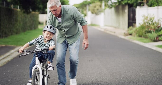 Bike, grandfather and boy learning outdoor on road, helping and bonding. Family, love and happy grandpa teaching child or kid how to ride bicycle, caring and enjoying quality time together outdoors.