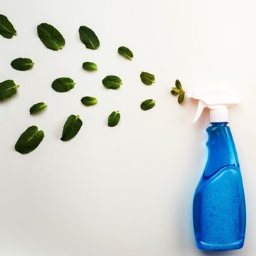 Detergent Blue Bottle With White Cap On A White Background Spray A Fresh Mint Leaves