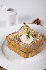 French toast with butter ball and powdered sugar