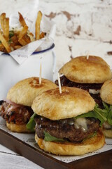Burgers with large patties; grilled buns, lettuce, cheese and fries