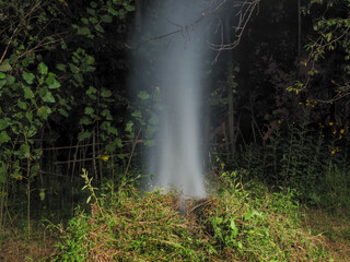 Smoke in the garden in the dark of night. Burn the leaves of trees in the garden.