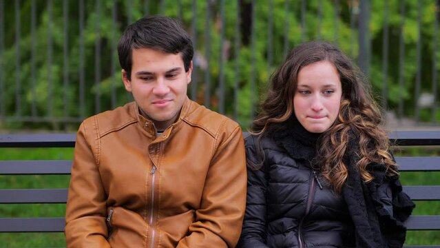 first date - shy couple look at each other and sneak kisses
