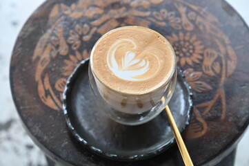 Latte art in cappuccino coffee .coffee ,drawing in foam
, white coffee cup with heart ,shape latte art,coffee latte art