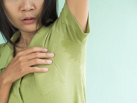 Woman Hyperhidrosis Wet Blue Shirt Underarm Hand Close Up. Problem Armpit Sweat Stains And Strong Body Odor. Hyperhidrosis Sweating.hygiene For Good Health Concept. Sweaty Under Arm.