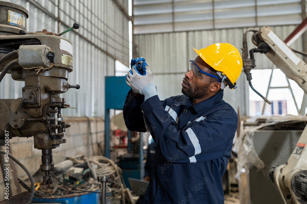 Poster factory male engineer worker checking or maintenance parts of metal lathe cnc machine in the industr