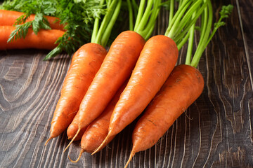 Fresh carrots on rustic background. Healthy vegetable food.