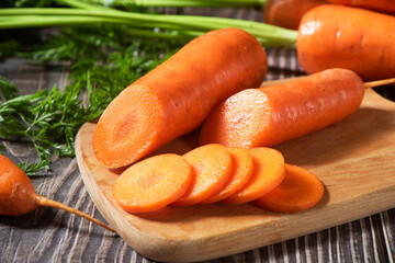 cut of fresh carrots on rustic wooden background. 