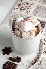 Hot drink cup with marshmallow and chocolate. Christmas home creations.