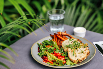 Outdoors shot of sweet potato and salad on the table