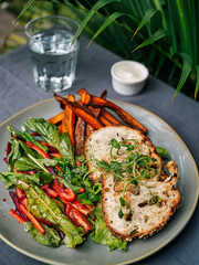 Outdoors shot of sweet potato and salad on the table