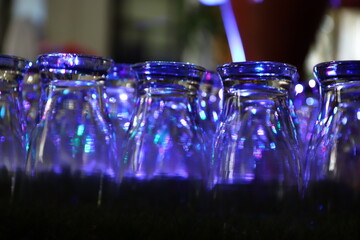 Defocused blurred abstract background, The glasses are neatly arranged against a very bright light background