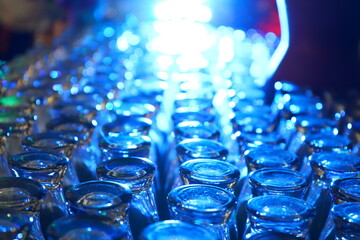 Defocused blurred abstract background, The glasses are neatly arranged against a very bright light background