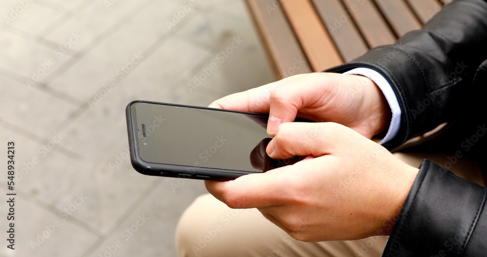 Poster close up of a man using mobile smart phone.