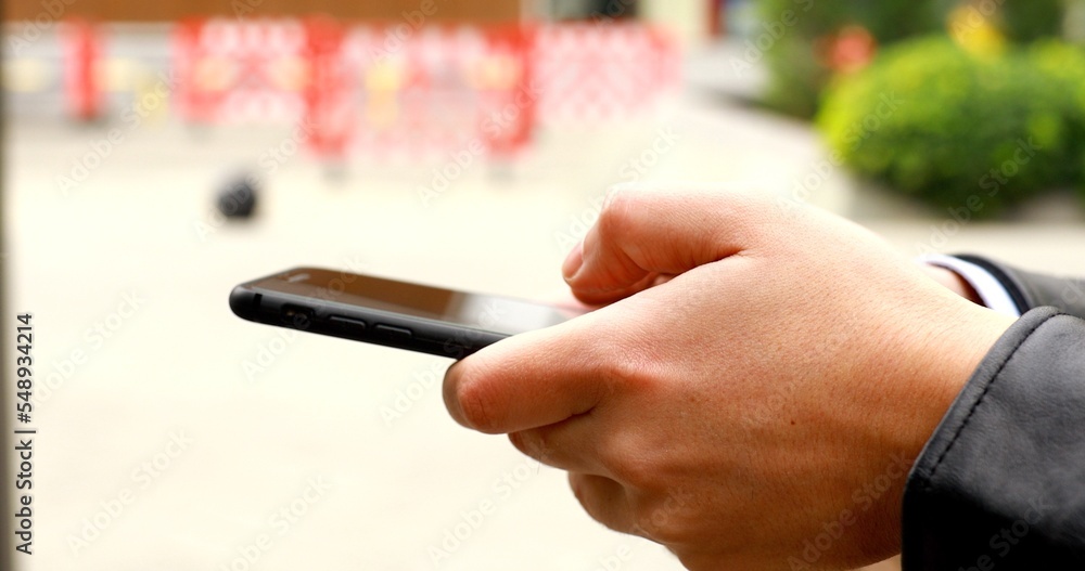 Poster close up of a man using mobile smart phone.