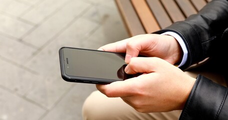 Close up of a man using mobile smart phone.