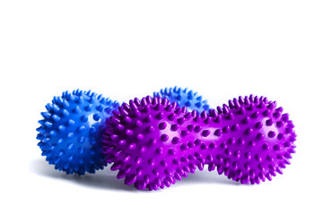Blue and purple double or peanut spikey balls massager for yoga pilates or stretching and fascia pain. Sports equipment for fitness isolated on a white background. Concept of sports massage. 