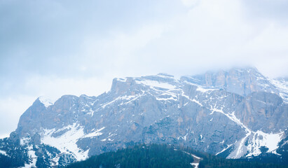 Fototapeta na wymiar Mountain peaks with snow against a cloudy sky