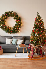 Living room interior. Christmas tree and wreath. New Year celebration. Vacation rentals. Winter holidays and vacations.