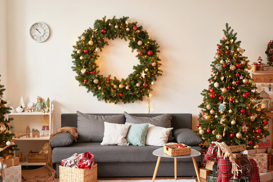 Living room interior. Christmas tree and wreath. New Year celebration. Vacation rentals. Winter holidays and vacations.