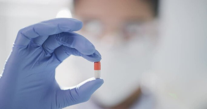 Scientist hand holding a pill, tablet or medicine for clinic trial, research or healthcare. Science, development and closeup of chemist with medical capsule or supplement in pharmaceutical laboratory