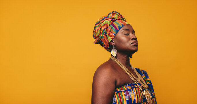 Ghanaian woman wearing traditional clothing in a studio
